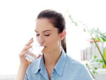 woman-drinking-glass-water-morning