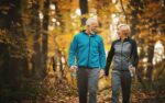 Retired couple walking in the fall -Your Annual Enrollment Game Plan